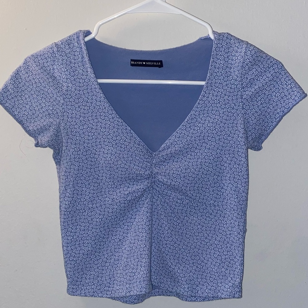 Brandy Melville. Light blue tee with floral print. Size xs/s